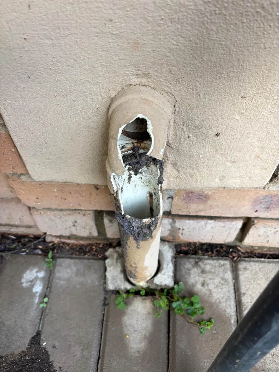 Corroded downpipe before repair