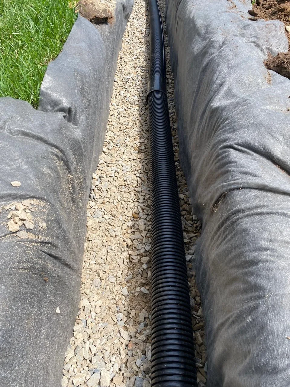Finished French drain packed with gravel